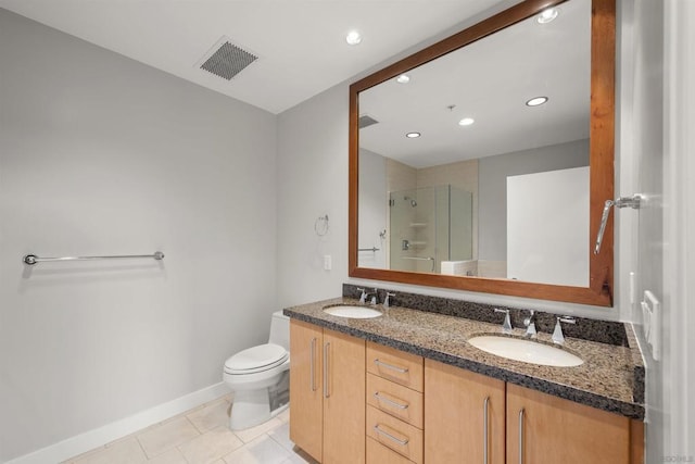 bathroom featuring toilet, tile patterned flooring, a shower with shower door, and vanity