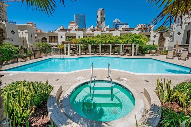 view of pool with a hot tub