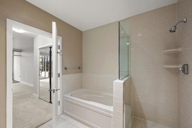 bathroom with tile patterned flooring and independent shower and bath