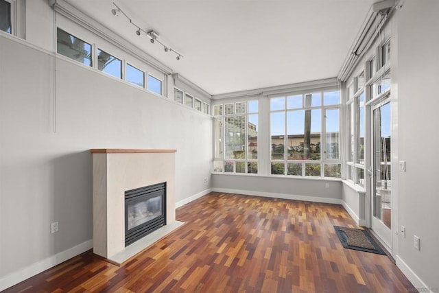 unfurnished sunroom featuring rail lighting