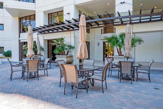 view of patio / terrace with a pergola and a balcony