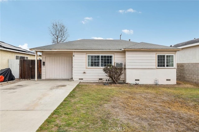 ranch-style house featuring a front lawn and a garage