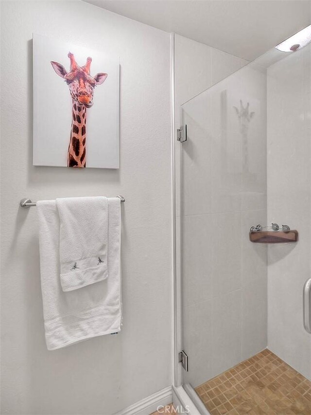 bathroom with a shower with shower door