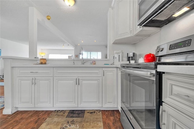 kitchen with white cabinets, stainless steel electric range oven, and sink