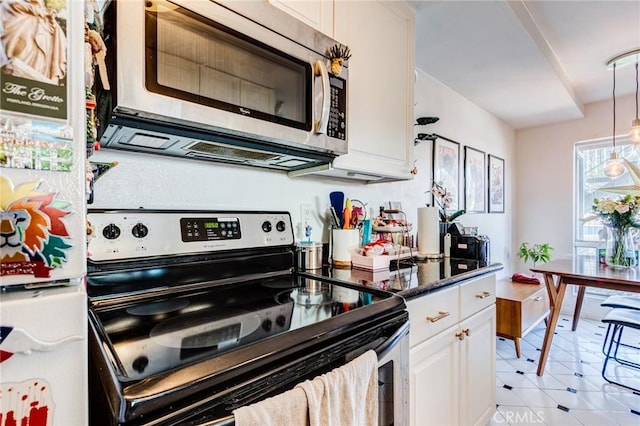 kitchen with pendant lighting, white cabinetry, light tile patterned floors, and stainless steel appliances