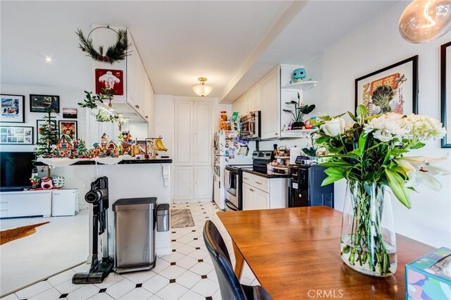 kitchen with white cabinets and appliances with stainless steel finishes