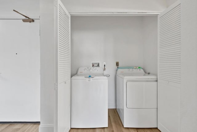 washroom featuring separate washer and dryer and light wood-type flooring