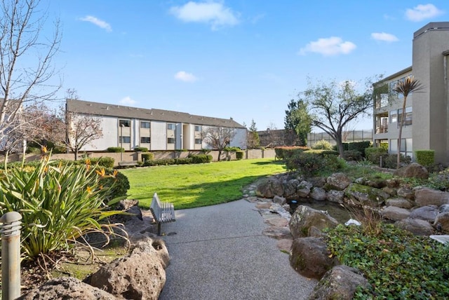 view of home's community featuring a lawn