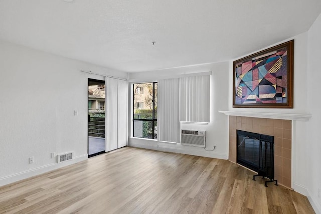 unfurnished living room with a fireplace and light hardwood / wood-style floors