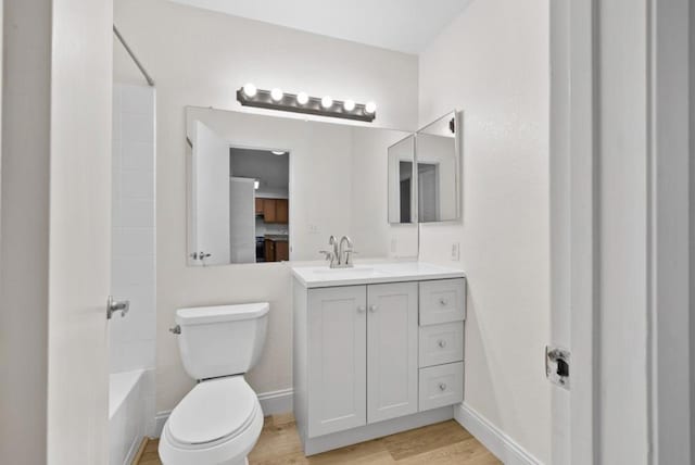 full bathroom featuring vanity, hardwood / wood-style floors,  shower combination, and toilet