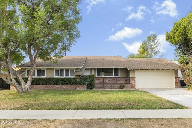 ranch-style home featuring a front lawn and a garage