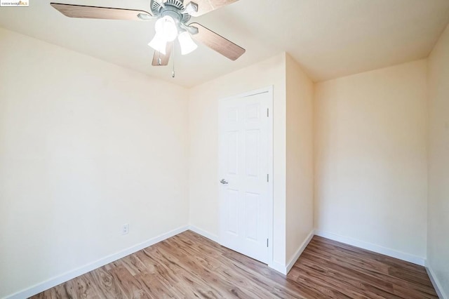 spare room with ceiling fan and wood-type flooring