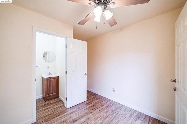 unfurnished bedroom featuring ceiling fan, light hardwood / wood-style floors, and ensuite bathroom