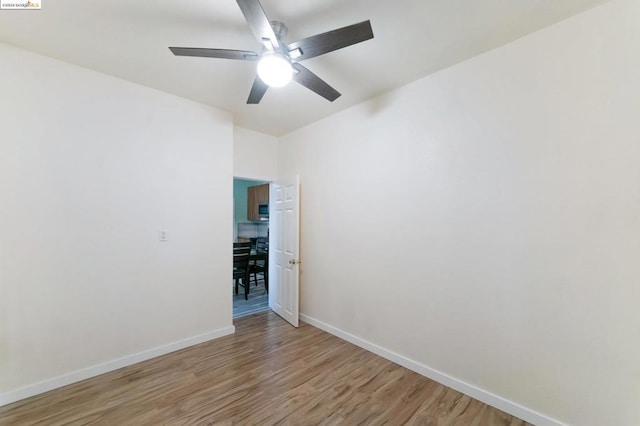 unfurnished room with ceiling fan and light hardwood / wood-style floors