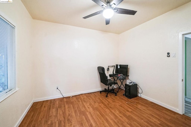 unfurnished office featuring ceiling fan and hardwood / wood-style floors