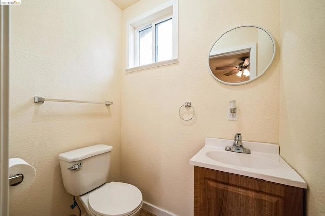 bathroom with ceiling fan, toilet, and vanity