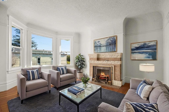 living room featuring a textured ceiling and dark hardwood / wood-style floors