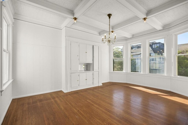 interior space with a wealth of natural light, beam ceiling, and coffered ceiling