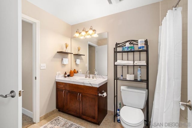 bathroom with a shower with curtain, tile patterned floors, vanity, and toilet