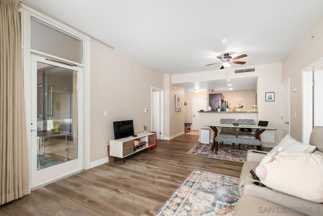 living room with ceiling fan and hardwood / wood-style flooring