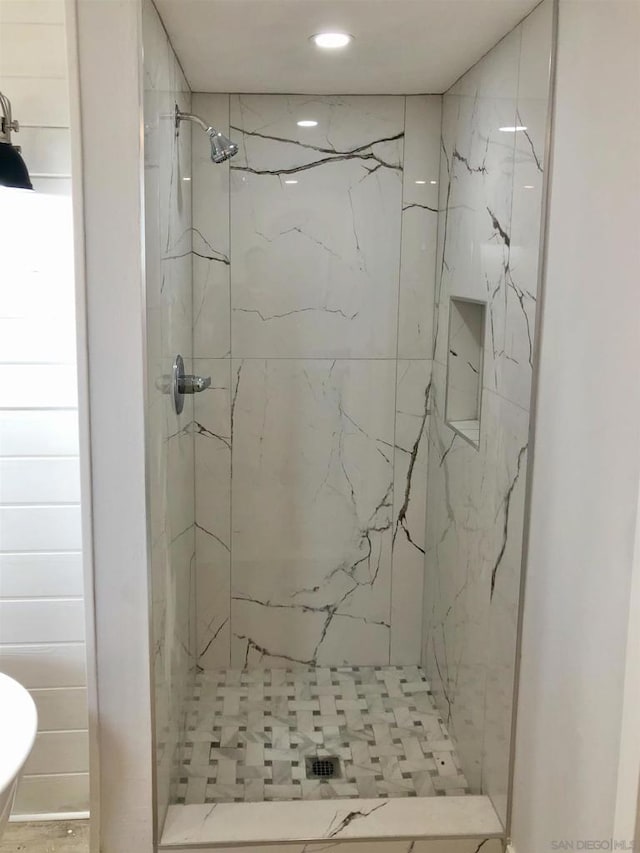 bathroom with a tile shower