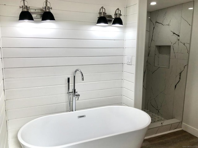 bathroom with plus walk in shower and wood-type flooring