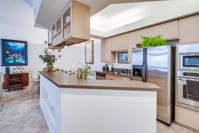 kitchen featuring sink, appliances with stainless steel finishes, and cream cabinets