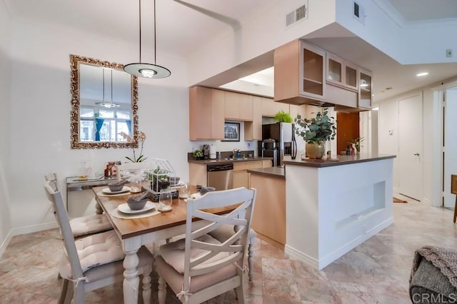 kitchen featuring appliances with stainless steel finishes, crown molding, and pendant lighting