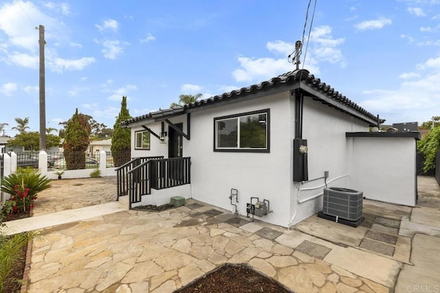 back of property with a patio area and cooling unit