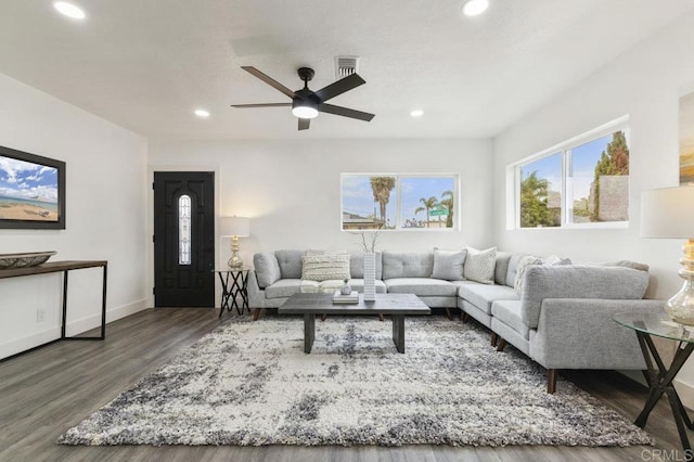 living room with ceiling fan and dark wood-type flooring