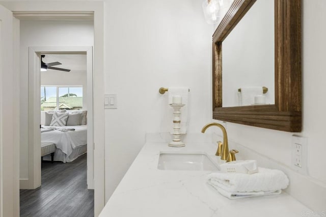 bathroom with ceiling fan, vanity, and hardwood / wood-style floors