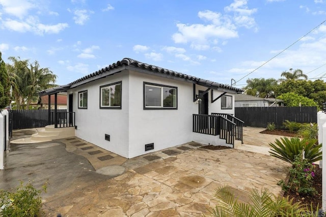 view of side of home with a patio area