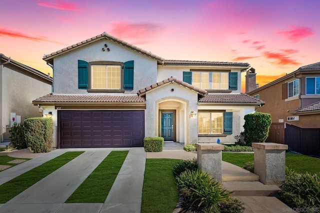 mediterranean / spanish home featuring a garage