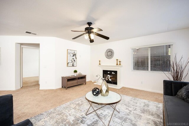 carpeted living room featuring ceiling fan