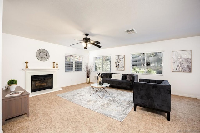 carpeted living room featuring ceiling fan