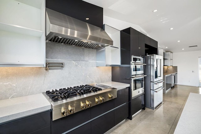 kitchen featuring tasteful backsplash, wall chimney range hood, and stainless steel appliances