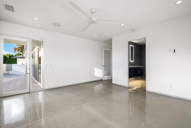 spare room featuring ceiling fan and concrete flooring