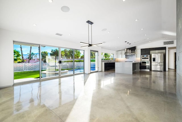 unfurnished living room featuring ceiling fan and lofted ceiling