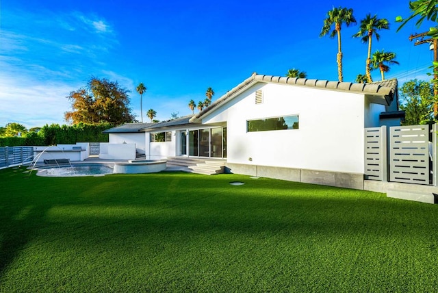 back of house with pool water feature and a lawn