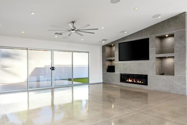 unfurnished living room featuring ceiling fan, lofted ceiling, and a tiled fireplace