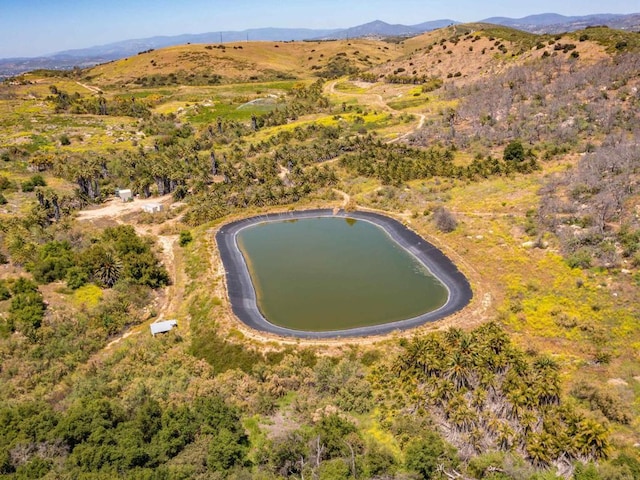 bird's eye view with a water and mountain view