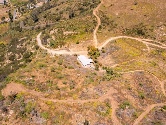 birds eye view of property with a rural view