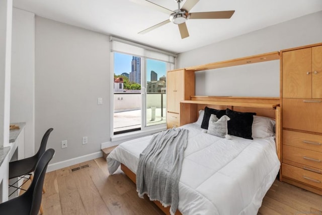 bedroom with ceiling fan and light hardwood / wood-style floors