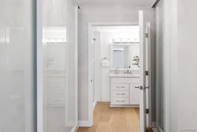 bathroom with hardwood / wood-style flooring and vanity