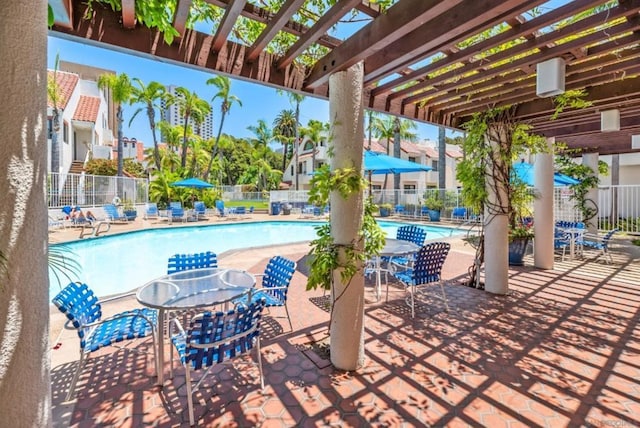 view of patio with a pergola and a community pool