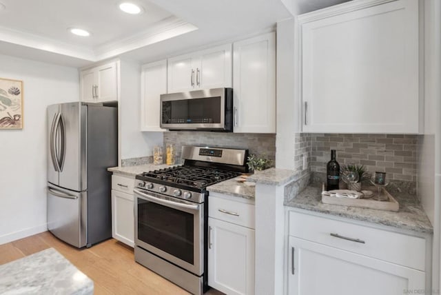 kitchen with white cabinets and appliances with stainless steel finishes