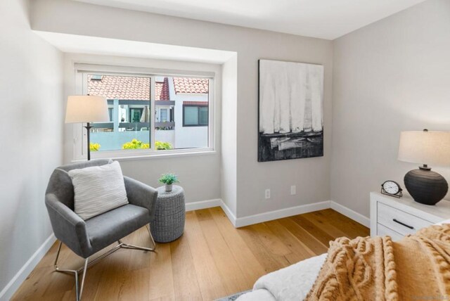 living area with hardwood / wood-style flooring