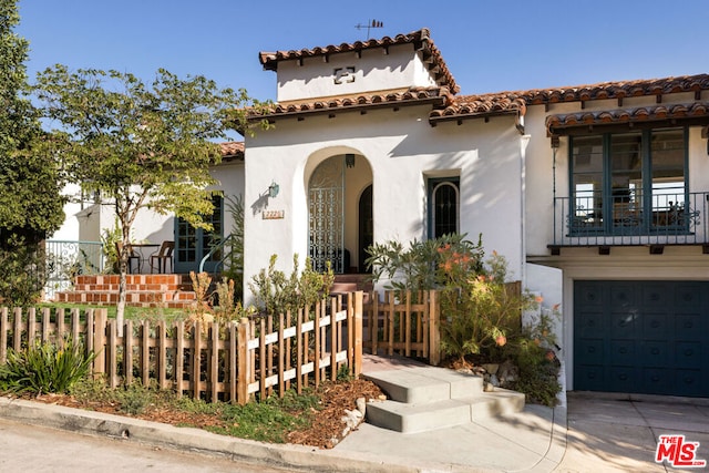 mediterranean / spanish home with a garage