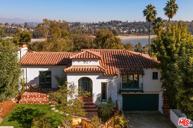 mediterranean / spanish-style home featuring a garage