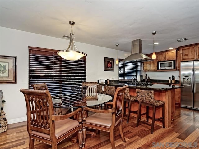 dining area with dark hardwood / wood-style floors